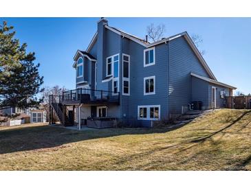 Stunning two-story home with a large deck, backyard and a charming blue exterior at 1625 Adobe Pl, Highlands Ranch, CO 80126