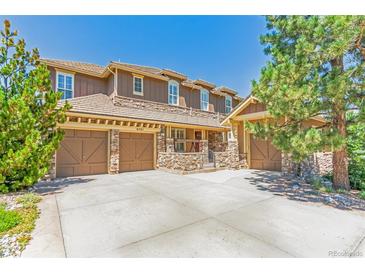 Charming home featuring a three-car garage and beautiful stone accents enhancing the exterior's curb appeal at 6761 Mary Ct, Castle Pines, CO 80108