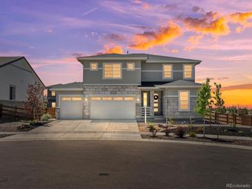 Beautiful two-story home featuring a three-car garage and stone accents, perfect for Gathering living at 3453 N Gold Bug Ct, Aurora, CO 80019