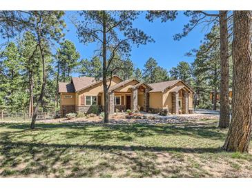 Stunning home with stone accents and lush landscaping nestled among the trees at 731 Weston Rd, Larkspur, CO 80118