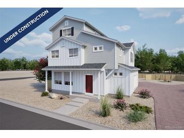 Charming two-story home with a red front door and a beautifully landscaped yard at 46545 Sunflower Ln, Bennett, CO 80102