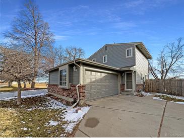 Gray two-story home with attached garage and landscaping at 4974 E 124Th Way, Thornton, CO 80241