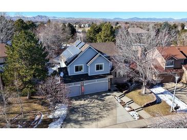 Charming two-story home with a two-car garage, solar panels, and mountain views at 6148 W Pacific Cir, Lakewood, CO 80227