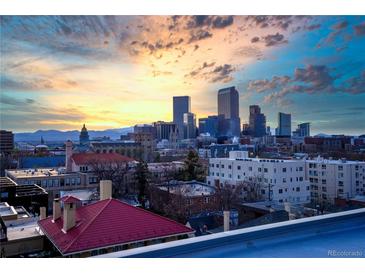 Sweeping city views showcasing Denver's skyline and the Rocky Mountains in the distance at sunset at 1300 N Ogden St # 304, Denver, CO 80218