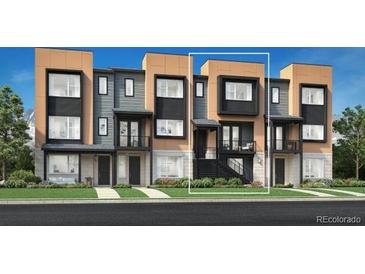 Modern townhome featuring a two-tone exterior with a private balcony and well-maintained landscaping at 815 Josephine Way, Superior, CO 80027