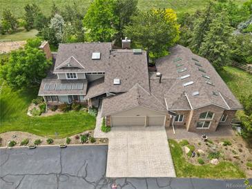 Expansive home featuring a three car garage, skylights, and mature trees at 6895 S Norfolk St, Foxfield, CO 80016