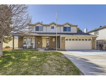 Charming two-story home with a well-manicured lawn, brick accents, and an attached two-car garage at 4160 E 115Th Pl, Thornton, CO 80233