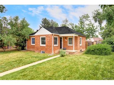 Charming red brick home with a well-manicured lawn and mature trees at 2970 Leyden St, Denver, CO 80207