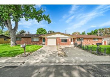 Charming brick home with a well-maintained front yard and inviting curb appeal at 5175-5185 Simms Pl, Wheat Ridge, CO 80033