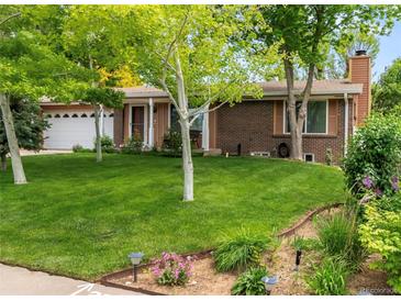 Charming brick home with a well-manicured lawn and mature trees at 2112 S Olathe St, Aurora, CO 80013