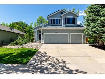 Charming two-story home with a well-maintained lawn, spacious driveway, and attached two-car garage at 10765 Fremont Dr, Parker, CO 80134