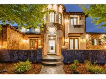 Grand entrance of home with stone accents, arched doorway, and manicured landscaping creating curb appeal at 1525 W 141St Way, Westminster, CO 80023