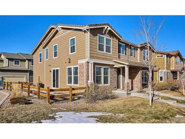 Two-story townhome with a fenced yard and landscaping at 10298 Tall Oaks Cir, Parker, CO 80134