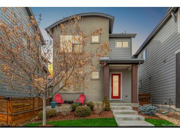 Charming two-story home with a red front door, modern design, and well-kept front yard at 6777 Larsh Dr, Denver, CO 80221