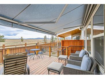 Relaxing deck area with comfortable seating and scenic mountain views at 15226 W 93Rd Ave, Arvada, CO 80007