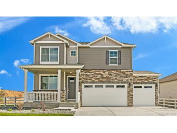 Charming two-story home featuring a stone facade, neutral siding, a welcoming porch, and a three-car garage at 226 Chardon Ave, Brighton, CO 80601