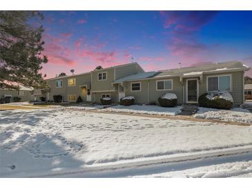 Inviting townhouse showcases a well-maintained front yard and a charming covered entrance with fresh snowfall at 5721 W 92Nd Ave # 96, Westminster, CO 80031