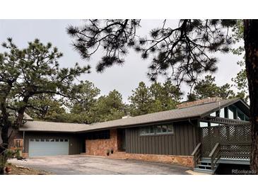 Charming single-story home with a 2-car garage and a beautifully landscaped front yard, offering serene mountain living at 21859 Grandview Ave, Golden, CO 80401