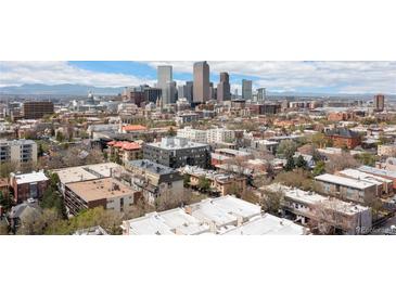 Expansive city view showcasing the Denver skyline with mountains in the distance, highlighting urban living at 1310 N Corona St # A, Denver, CO 80218