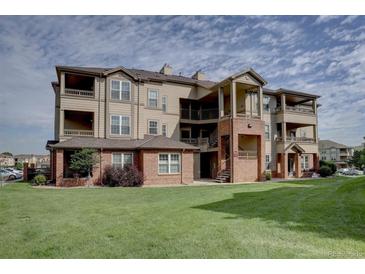 Spacious multi-story condo with multiple balconies, brick accents, and well maintained green space at 12914 Ironstone Way # 201, Parker, CO 80134