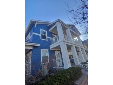 Charming blue two-story home featuring private balconies and inviting architectural details at 2793 Roslyn St, Denver, CO 80238