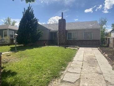 Ranch home with brick facade, driveway, and grassy yard at 1645 Iola St, Aurora, CO 80010