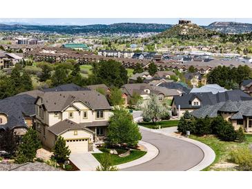 Wide angle view of homes in a neighborhood with city and mountain views at 2115 Holmby Ct, Castle Rock, CO 80104