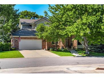 Charming brick home with mature landscaping and a spacious driveway at 74 Blue Heron Dr, Greenwood Village, CO 80121