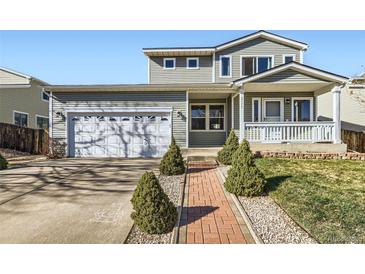 Charming two-story home featuring a two-car garage, inviting front porch, and landscaped front yard at 2175 E 126Th Way, Thornton, CO 80241