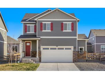 Charming two-story home with red shutters and a two-car garage, offering classic curb appeal at 45810 Laceleaf Dr, Bennett, CO 80102