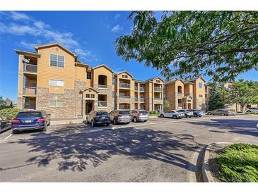 Inviting condo complex featuring stone accents, balconies, and ample parking in a well-maintained community at 17497 Nature Walk Trl # 302, Parker, CO 80134