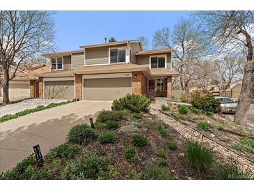 Charming two-story home with a well-maintained lawn and inviting curb appeal at 1571 S Trenton Ct, Denver, CO 80231