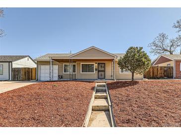 Charming single-story home featuring a well-manicured lawn and inviting entrance, creating a welcoming curb appeal at 3016 S Grape Way, Denver, CO 80222