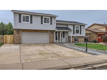 Charming two-story home featuring an attached two-car garage, well-maintained lawn, and inviting entryway at 450 Lone Pine St, Fort Lupton, CO 80621