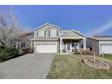Charming two-story home with a well-maintained front yard and inviting covered porch at 10061 Apollo Bay Way, Highlands Ranch, CO 80130