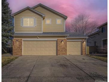 Two-story home showcasing three garage doors and a well-maintained driveway at 17076 Foxton Dr, Parker, CO 80134