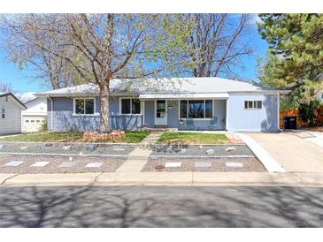 Charming light blue single story home with mature trees, tidy landscaping, and a welcoming walkway at 2561 S Carey Way, Denver, CO 80222