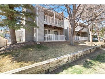 Charming condo exterior featuring multiple balconies and a well-maintained lawn at 18391 E Kepner Pl # 205, Aurora, CO 80017