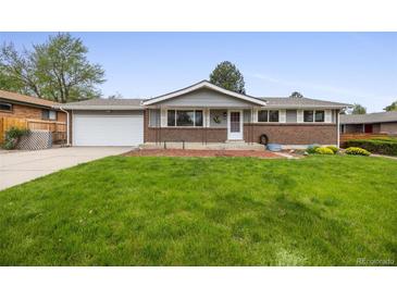 Charming single-story home with a well-maintained lawn, brick accents, and a two-car garage at 1185 Yank St, Golden, CO 80401