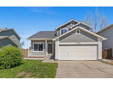 Charming two-story home featuring a well-manicured lawn and an attached two-car garage at 1716 W Sunset St, Longmont, CO 80501