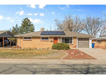 Charming single-story brick home featuring a well-manicured front yard and solar panels at 8235 Auburn Ln, Westminster, CO 80031