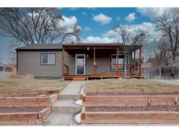 Charming home featuring a covered front porch with wooden accents and a well-maintained front yard at 3290 S Holly St, Denver, CO 80222