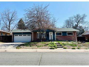 Charming brick home with a two-car garage and well-maintained front yard at 2964 S Yates St, Denver, CO 80236