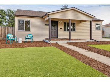 Charming single-story home with a cozy front porch and an inviting, well-maintained lawn at 970 S Canosa Ct, Denver, CO 80219
