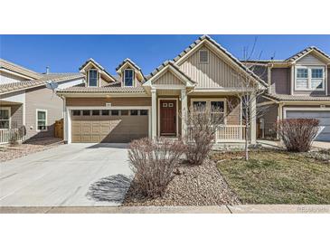 Charming home featuring a two-car garage, well-maintained landscaping, and a welcoming front entrance at 1896 Hogan Ct, Castle Rock, CO 80109