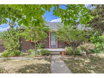 Charming home exterior with a walkway and lush landscaping under a blue sky at 1557 North St, Boulder, CO 80304