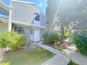 Charming two-story townhome with newly installed gray siding and a lush green landscaped front yard at 56 S Nome St, Aurora, CO 80012