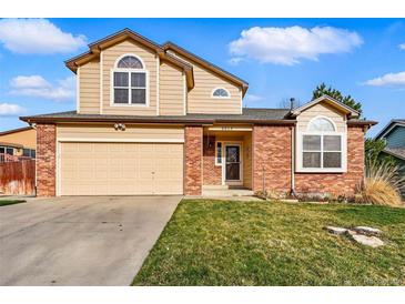 Charming two-story home with a well-maintained lawn and attached two-car garage at 4014 S Kirk Way, Aurora, CO 80013