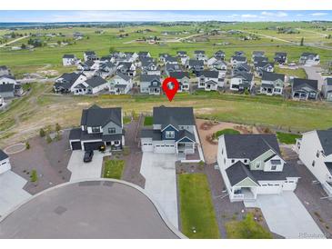 Beautiful aerial view of a two-story home in a suburban neighborhood with well-maintained landscaping at 1172 Elbridge Cir, Elizabeth, CO 80107