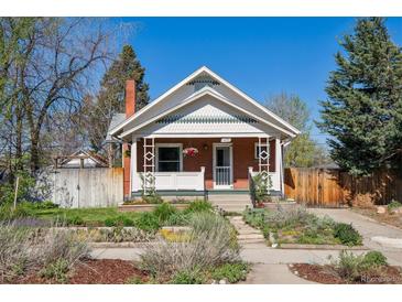Charming brick bungalow featuring a landscaped front yard and inviting front porch on a sunny day at 3725 S Acoma St, Englewood, CO 80110